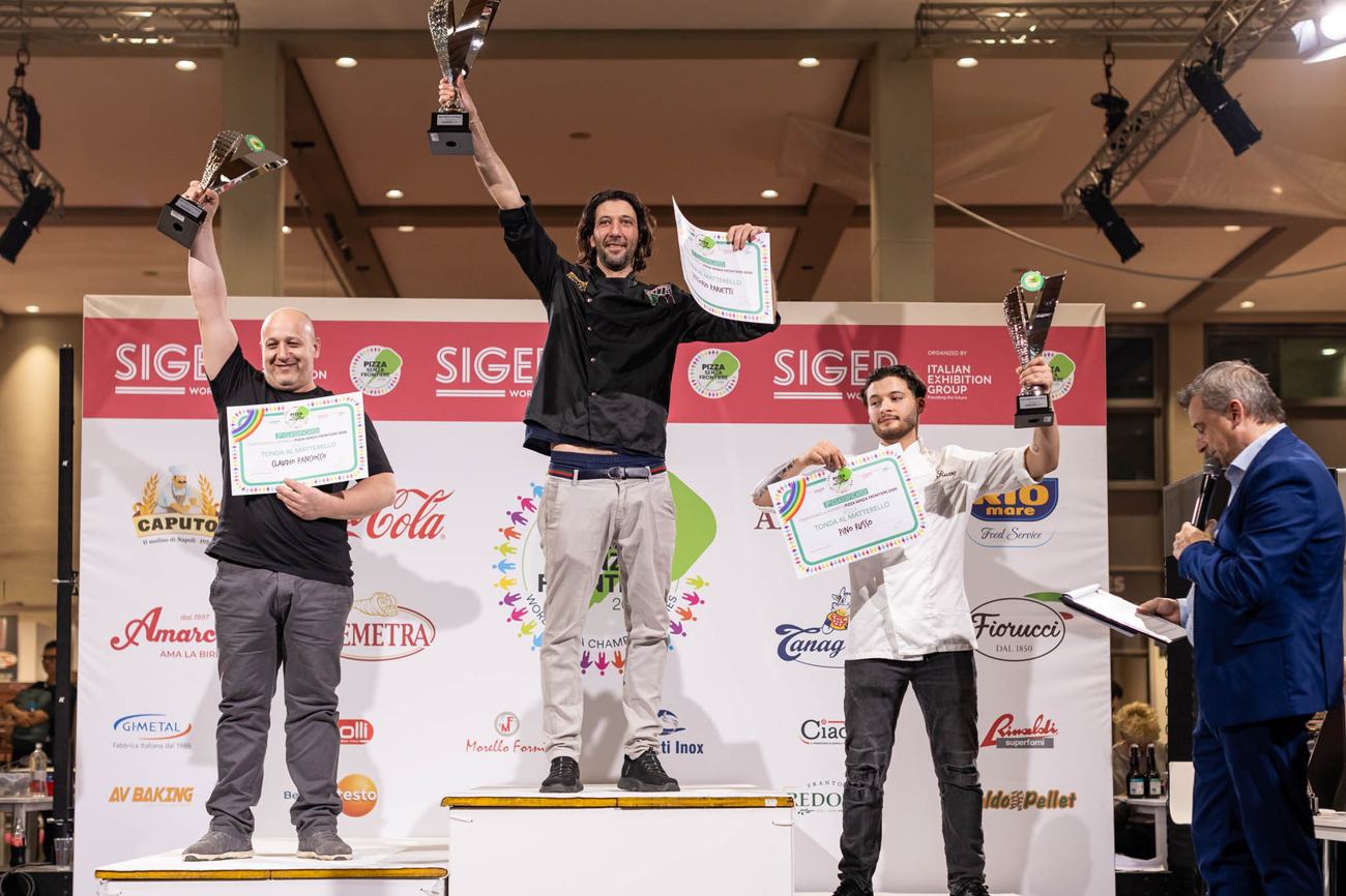 Gregorio Parietti, 2026 world champion, on the top step of the podium with the trophy